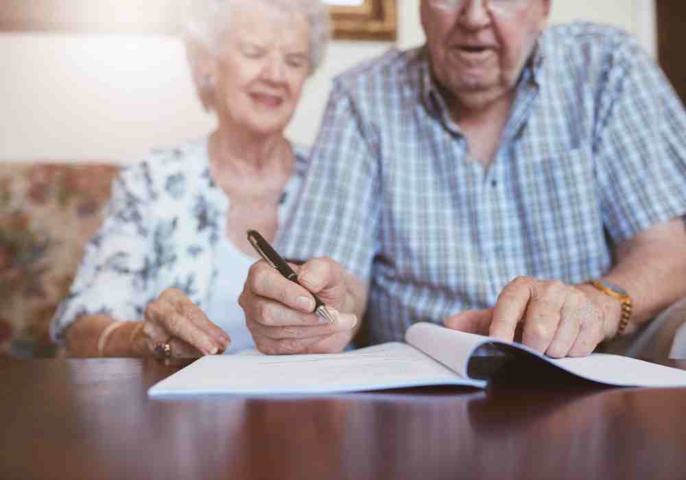 Couple signing a will, trust or power of attorney